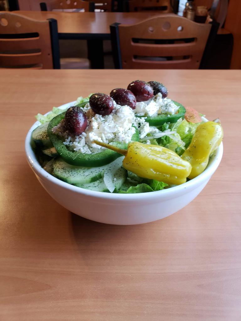 Greek Salad · Romaine, tomatoes, onions, peppers, cucumbers, feta cheese, Kalamata olives and pepperoncini. Served with oil & vinegar