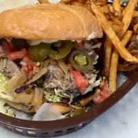 Carnitas (Pork) Sandwich · Marinated and slow-roasted pork served over slaw with caramelized onion, roasted poblano, Te...