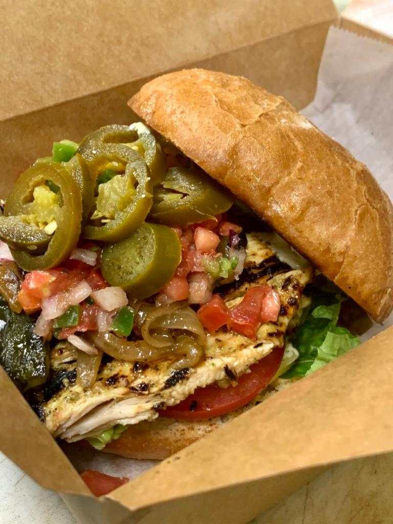 Loco Pollo (Grilled Chicken) Sandwich · Brined and grilled chicken breast served over lettuce and topped with roasted poblano, caramelized onion, Texisauce, poblano mayo, sliced tomato, jalapenos, and pico.