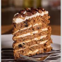 Carrot Cake · Studded with raisins, walnuts, and pineapple,  finished with a smooth cream cheese icing.