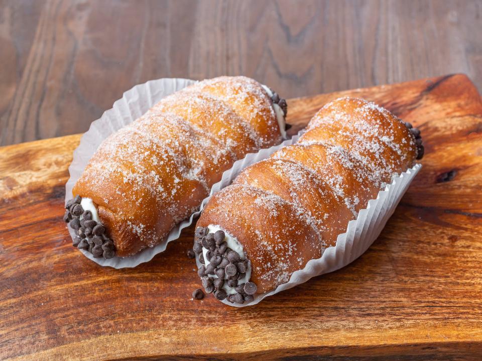 Cartoccio · Doughnut dough, rolled, fried, cooled, filled w/ cannoli cream and dusted with a granulated sugar & cinnamon mix