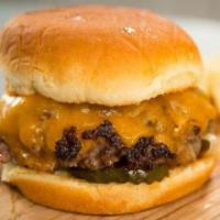 Cheddar Burger · Angus beef burger, caramelized onion, double cheddar cheese and barbecue sauce. Served with ...