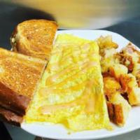 The Reuben Omelet · Made from scratch corned beef hash, sauerkraut and swiss cheese drizzled with Thousand Islan...