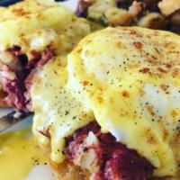 Irish Benedict · 2 poached eggs, on a bed of house-made corn beef hash on an English muffin, topped with a ri...