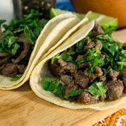 Steak Asada Taco · Our marinated steak asada that is cooked with a light amount of grilled onions and topped wi...