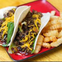The Garden Tacos · Folded tortilla with a variety of fillings such as meat or beans. 