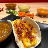 Bacon, Egg and Cheese Tacos · Crunchy bacon cut up over fluffy eggs and shredded Monterrey jack cheese served in a warm, h...