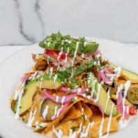 Nachos · Queso, Charred Corn, Black Beans, Avocado, Lime Crema, Pico de Gallo, Jalapeños, Pickled Onion