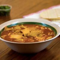 Menudo · Traditional Mexican soup made with beef stomach (tripe). Broth with red chilli pepper base.