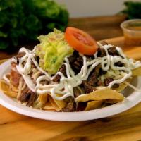 Nachos · They prepared with your choice of protein, beans, guacamole, sour cream, and Cotija cheese.