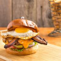 Sunny Burger · 1/3 lb burger with thick-cut bacon, cheddar cheese, sunny-side-up egg, lettuce, tomato, red ...