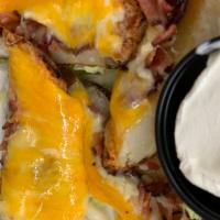Potato Skins · Pepper jack cheese, bacon bits, cheddar and sour cream.