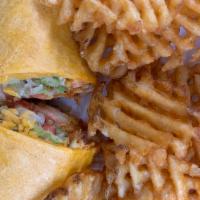 Buffalo Wrap · Chicken tender, spicy sauce, lettuce, tomato and cheddar. Wrapped in a yellow tortilla. Serv...