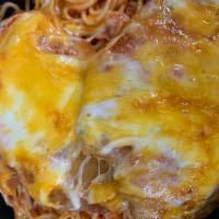 Chicken Parmigiana · Tomato basil sauce, mozzarella and cheddar over spaghetti.