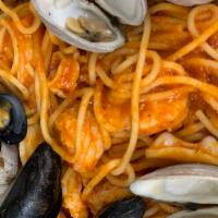 Seafood Fra Diavolo · Calamari, baby shrimp, mussels, little neck clams and spicy tomato basil sauce with spaghetti.