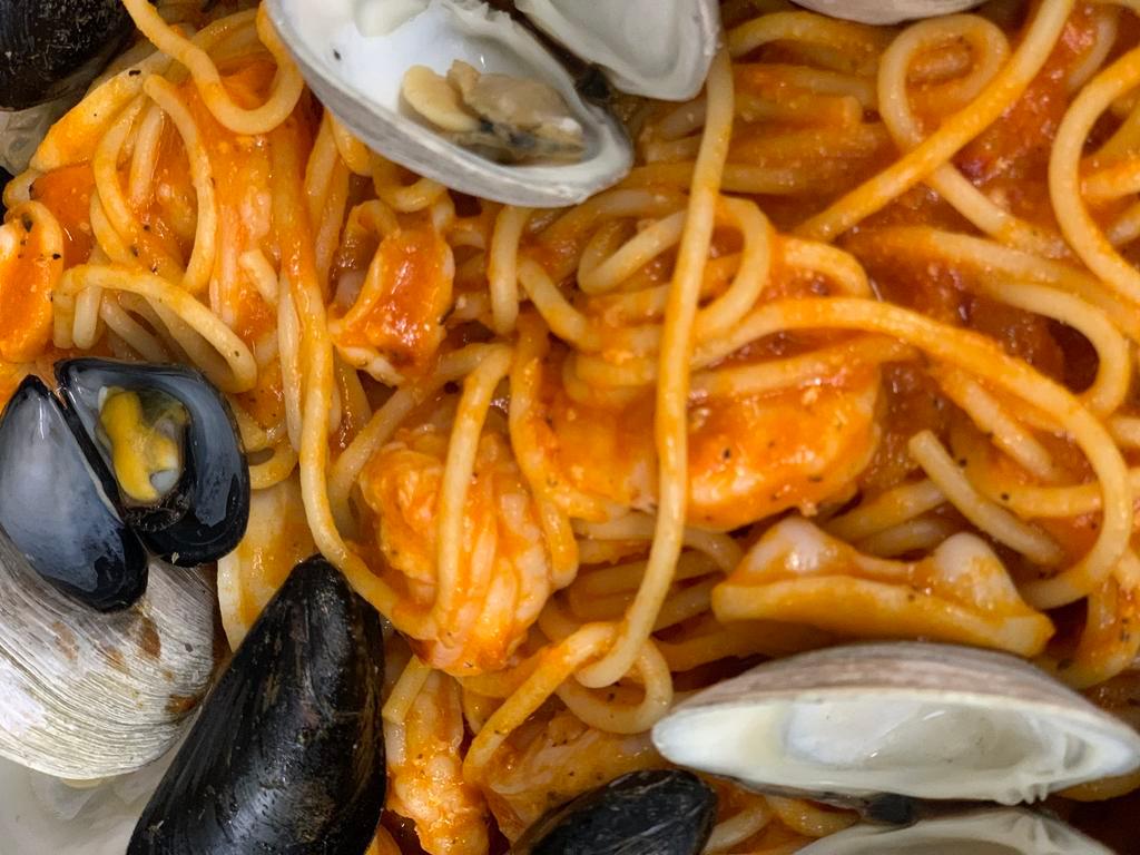 Seafood Fra Diavolo · Calamari, baby shrimp, mussels, little neck clams and spicy tomato basil sauce with spaghetti.