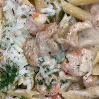 Rasta Pasta · Jerked baby shrimp and chicken, onions, peppers and penne pasta in a spicy cream sauce