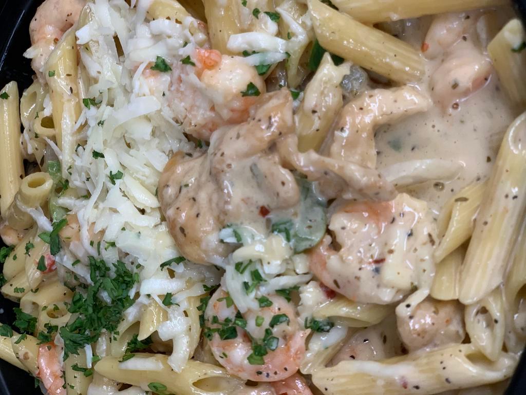 Rasta Pasta · Jerked baby shrimp and chicken, onions, peppers and penne pasta in a spicy cream sauce