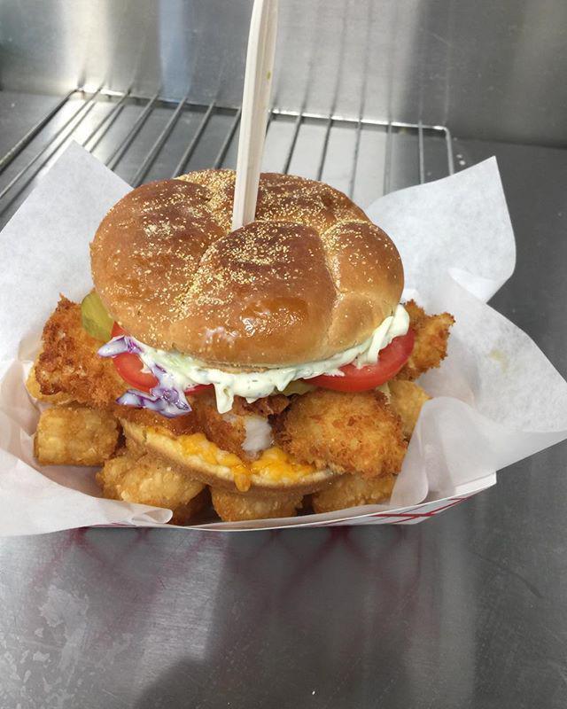 Fish Sandwich · Hand-dipped Alaskan cod on a toasted kaiser bun with tartar or mayo topped with pickles and coleslaw with tot's or equivalent.  Add cheese or tomatoes  for an additional charge.