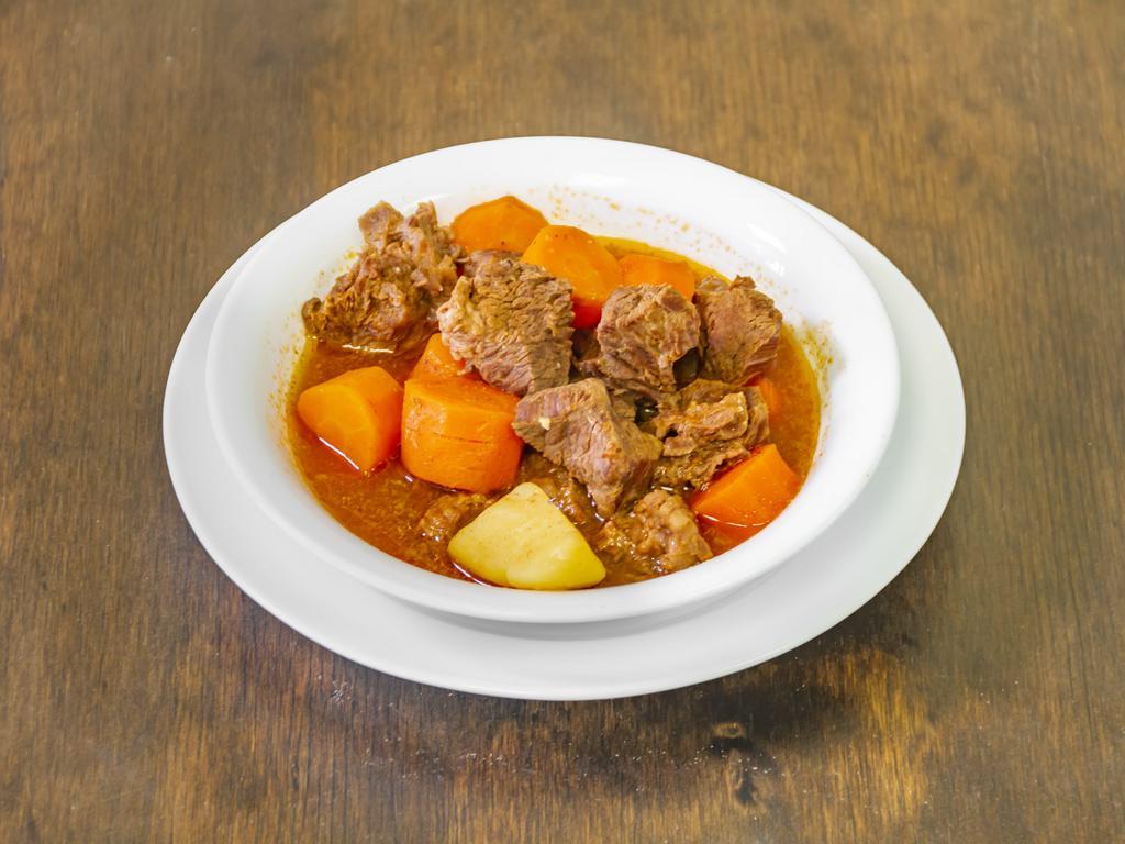 Beef Stew · Beef stew, served with rice, beans and salad.