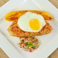 Tacu Tacu · Peruvian-style canary beans mixed with rice and topped with a well-done fried egg.