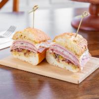 The HMC Sandwich · Our take on a New Orleans muffuletta: salami, mortadella, ham, provolone, olive salad, Cajun...