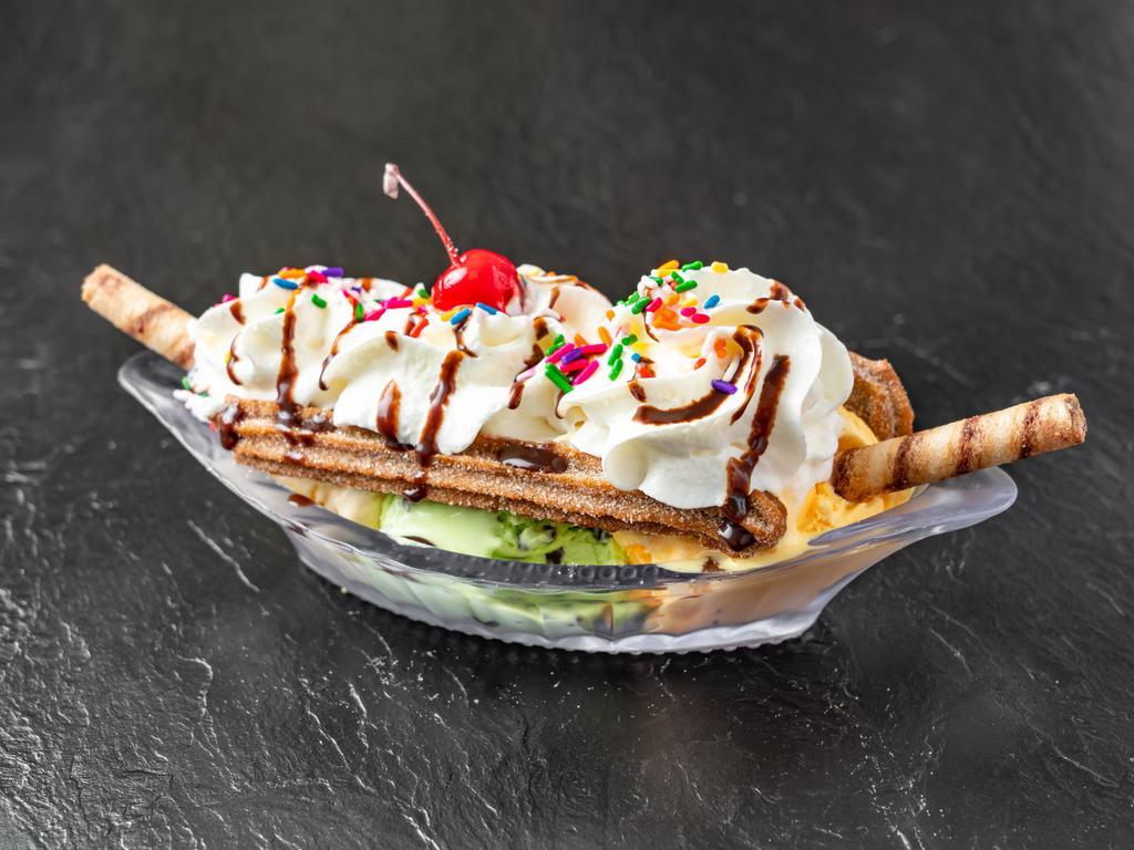 Churro Split · Comes with 3 choices of ice cream, whip cream, syrup ( choc, strawberry, and caramel), choc/ rainbow sprinkles, pirouline sticks, and a cherry on top