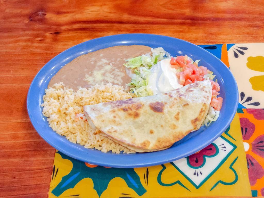 Gringa Toro Quesadilla · Grilled cheese quesadilla stuffed with your choice of meat and grilled onions and bell peppers. Served with rice, beans and salad.