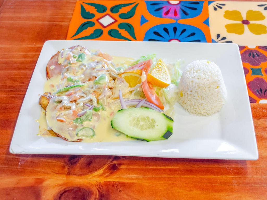 Pollo Monterrey · Grilled chicken breast covered with special creamy mushroom sauce and ham. Served with rice and salad.