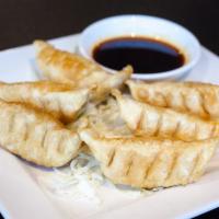 Pot Stickers · Deep-fried dumpling filled with vegetables and chicken.