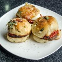 Meatball Slider (1) · Andouille meatballs inside our house-made garlic knots with house-made marinara and fresh mo...