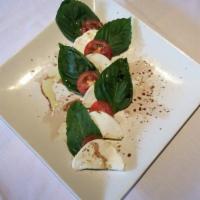 Margarita Insalata · Fresh mozzarella cheese, basil leaves, and sliced tomatoes, garnished with garlic, extra-vir...