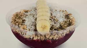 Vegan Berry Blast Acai Bowl · Acaí, dragon fruit, mango, and pineapple. Topped with granola, banana, and coconut.