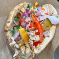 Chicken Shawarma on Pita · Flavorful chicken meat in a freshly baked pita pocket stuffed with hummus, Israeli salad and...