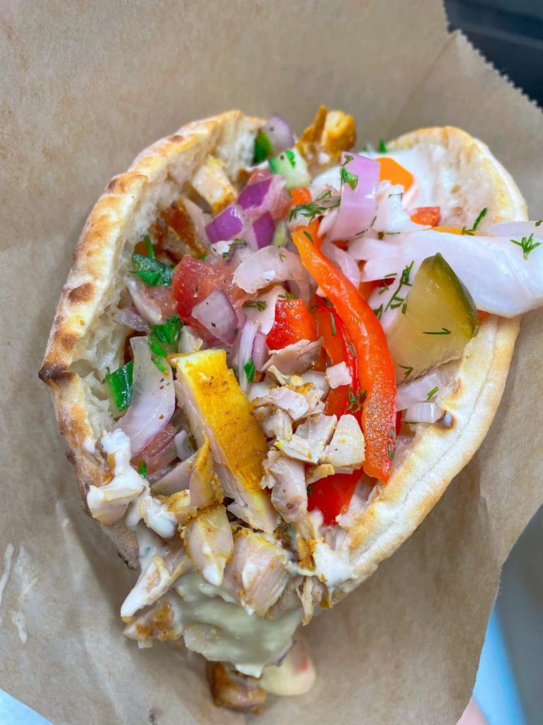 Chicken Shawarma on Pita · Flavorful chicken meat in a freshly baked pita pocket stuffed with hummus, Israeli salad and pickles. VGN 