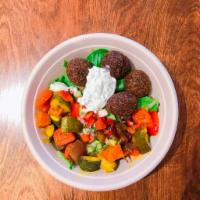 Falafel Salad · Our signature green falafel fried to perfection over mixed spring green salad, Israeli salad...