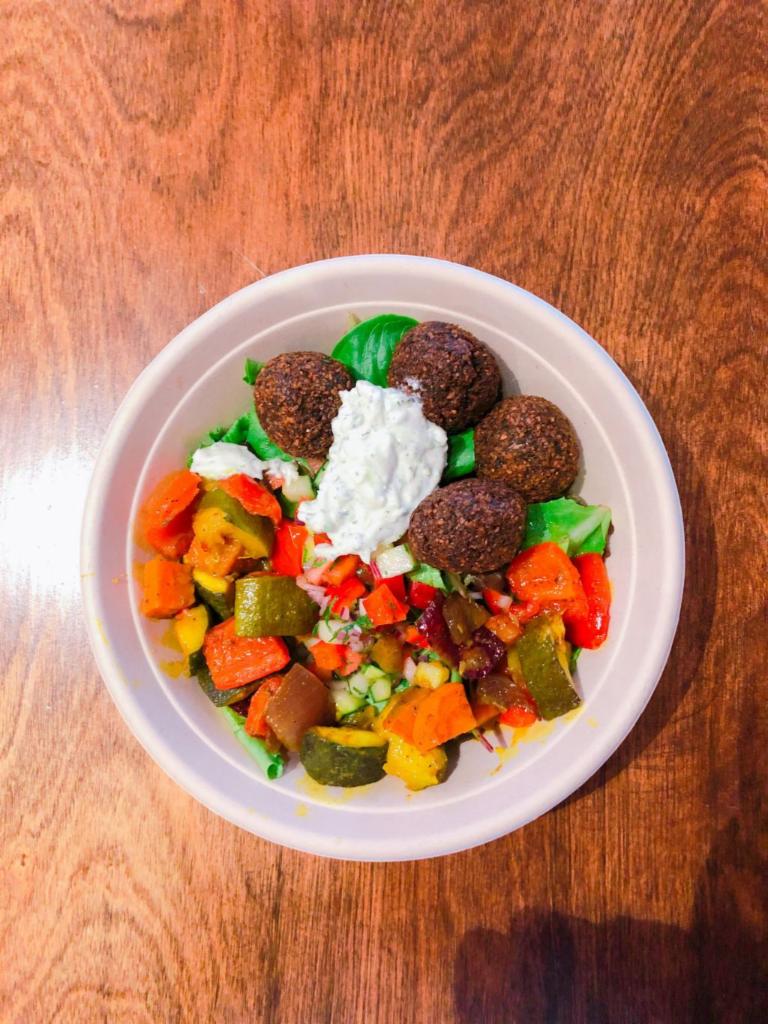 Falafel Salad · Our signature green falafel fried to perfection over mixed spring green salad, Israeli salad and Foreverything pickles. VEGAN. GLUTEN FREE.