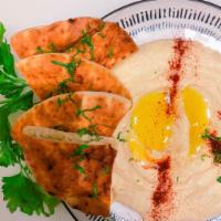Hummus (8 oz.) · Classic hummus with extra virgin oil on top, served with pita. VEGAN