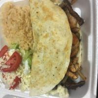 20. Quesadilla Texanna  · Grilled chicken, steak, shrimp, onion mushroom, rice, sour cream and salad.