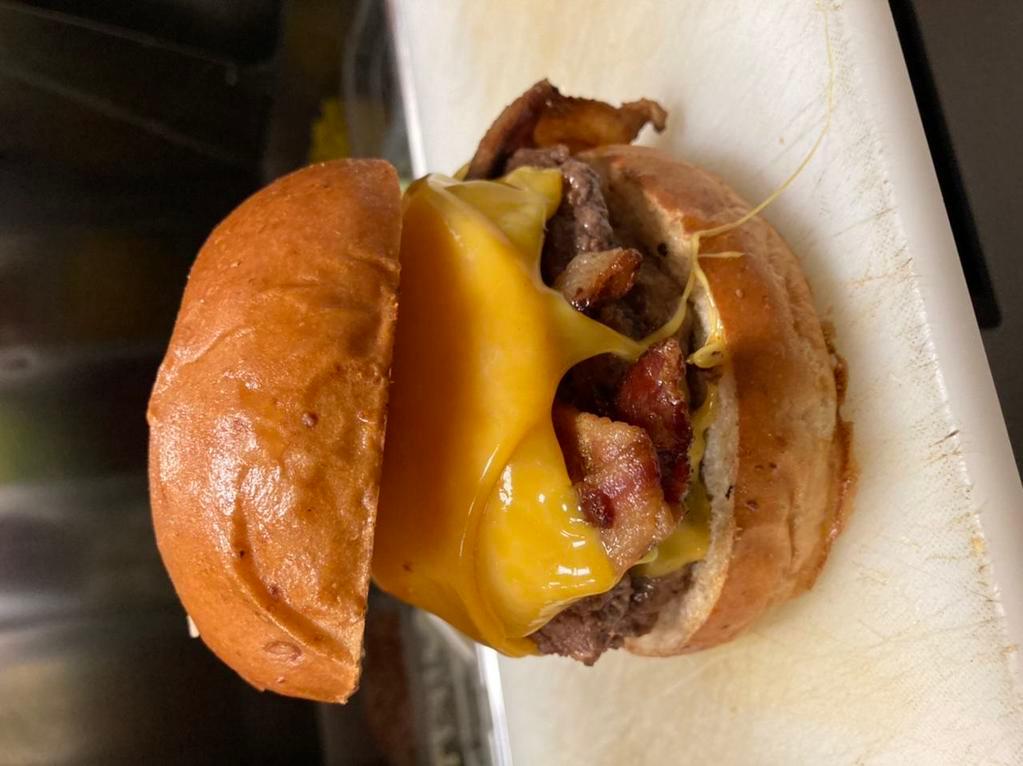 The Famous Burger · Stuffed with cheddar cheese and topped with loads of bacon and cheddar cheese.