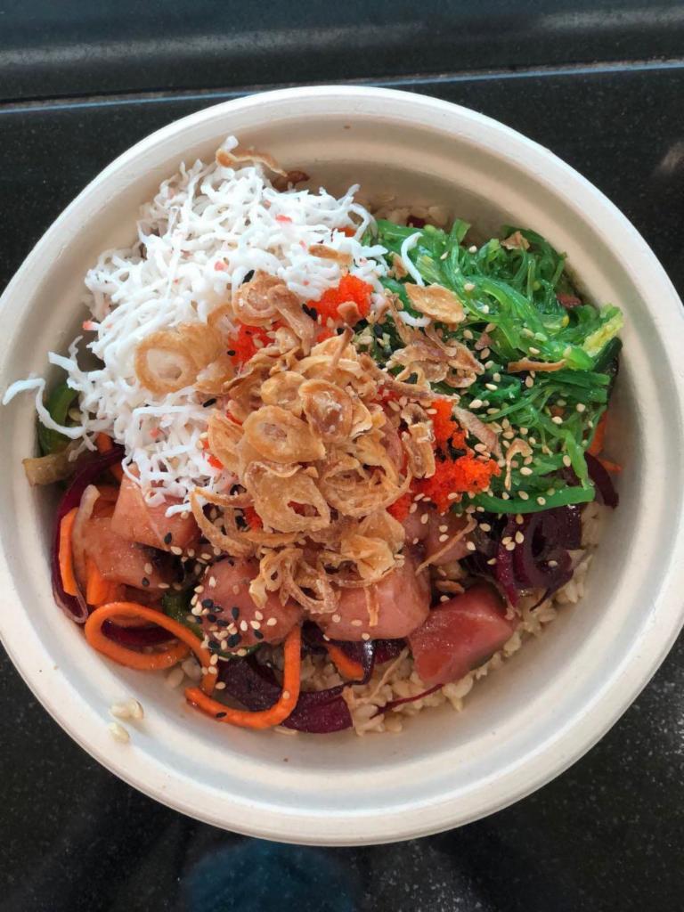 Spicy Hug · Ahi tuna, carrots, beets, seaweed salad, fish egg, jalapeno, scallion, red onion, sesame seeds, crab salad, crisp onion, spicy poke and spicy citrus ginger sauce.