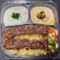 Kebab Plate · Beef kebabs, rice, salad , hummus, taziki, garlic sauce, hot sauce