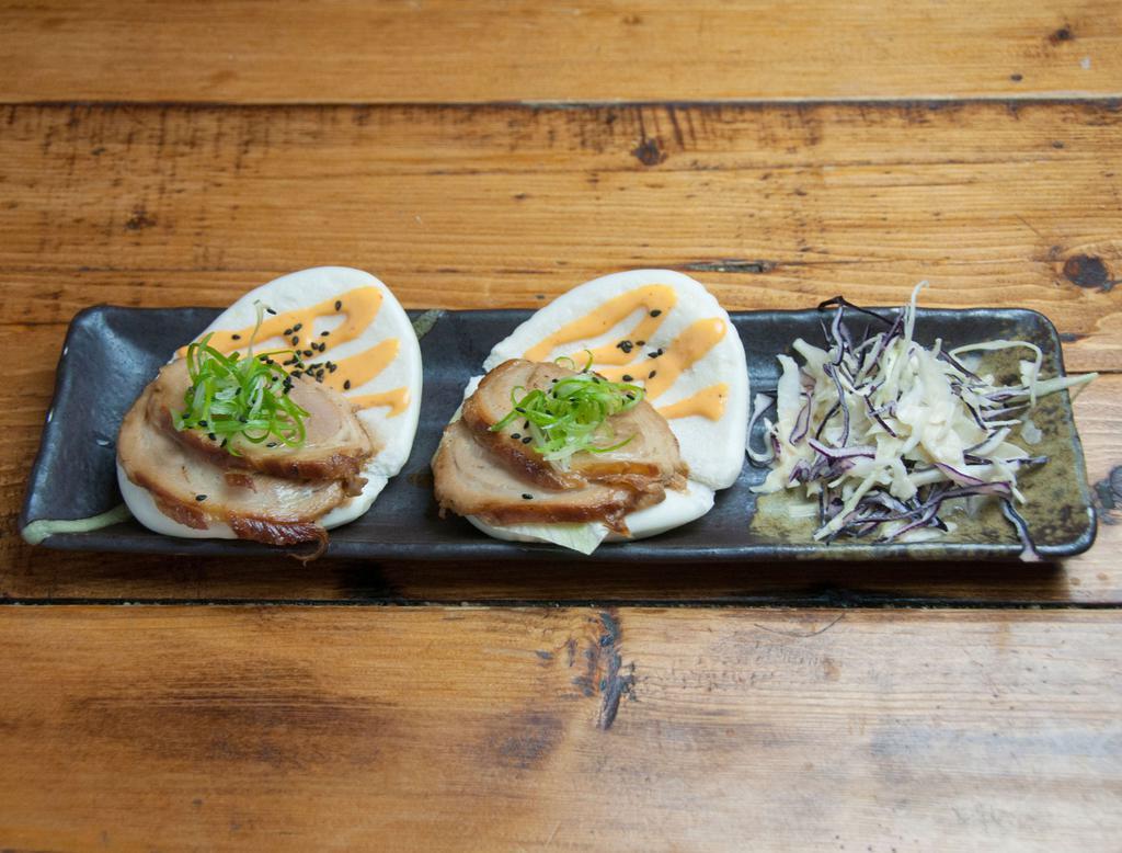 Pork Buns · Chashu pork, lettuce, and spicy mayo on steamed buns. Sprinkled with sesame seeds. Served with mixed slaw.