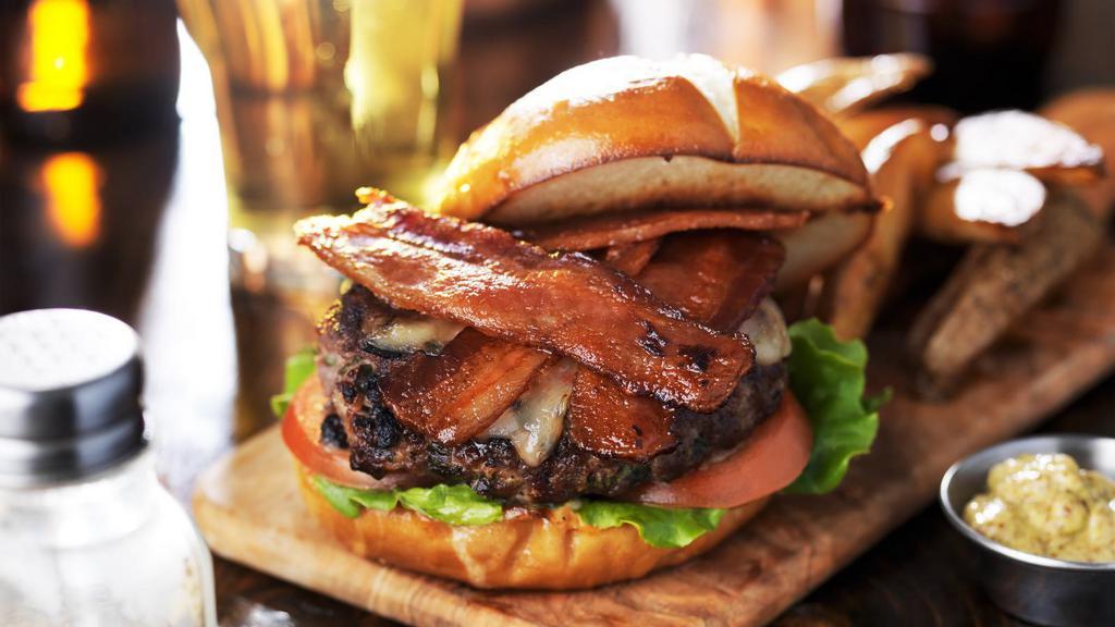 Bacon Cheeseburger · Juicy beef patty, creamy cheese, crispy bacon, lettuce, and tomatoes on a fresh bun.