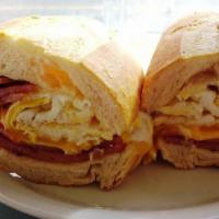 Hungry Man Sandwich · Three eggs with bacon, ham, cheese and home fries on a semolina hero. 