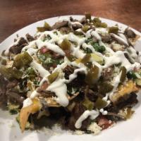 Nachos · Fried tortilla chips with cheese, shredded lettuce, pico de gallo, refried beans, sliced jal...