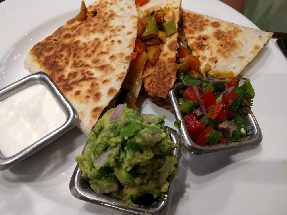 Vegetable Quesadilla · Mixed vegetables with cilantro, tomatoes & scallions. Served with guacamole, sour cream and pico de gallo.
