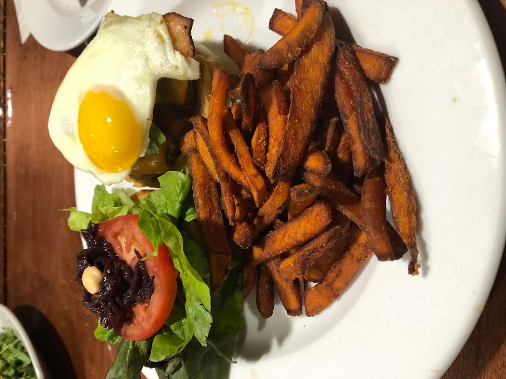 Luna's Burger · 7 oz. Angus beef burger with bacon, cheddar cheese, lettuce, tomato, avocado and sunny side up egg with a side of sweet potato fries.