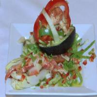 Aguacate Relleno de  Mariscos · Fresh avocado stuffed with chilled seafood salad