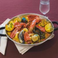 Paella Valenciana con Langosta Dinner · Lobster, seafood, chicken and rice sausage.